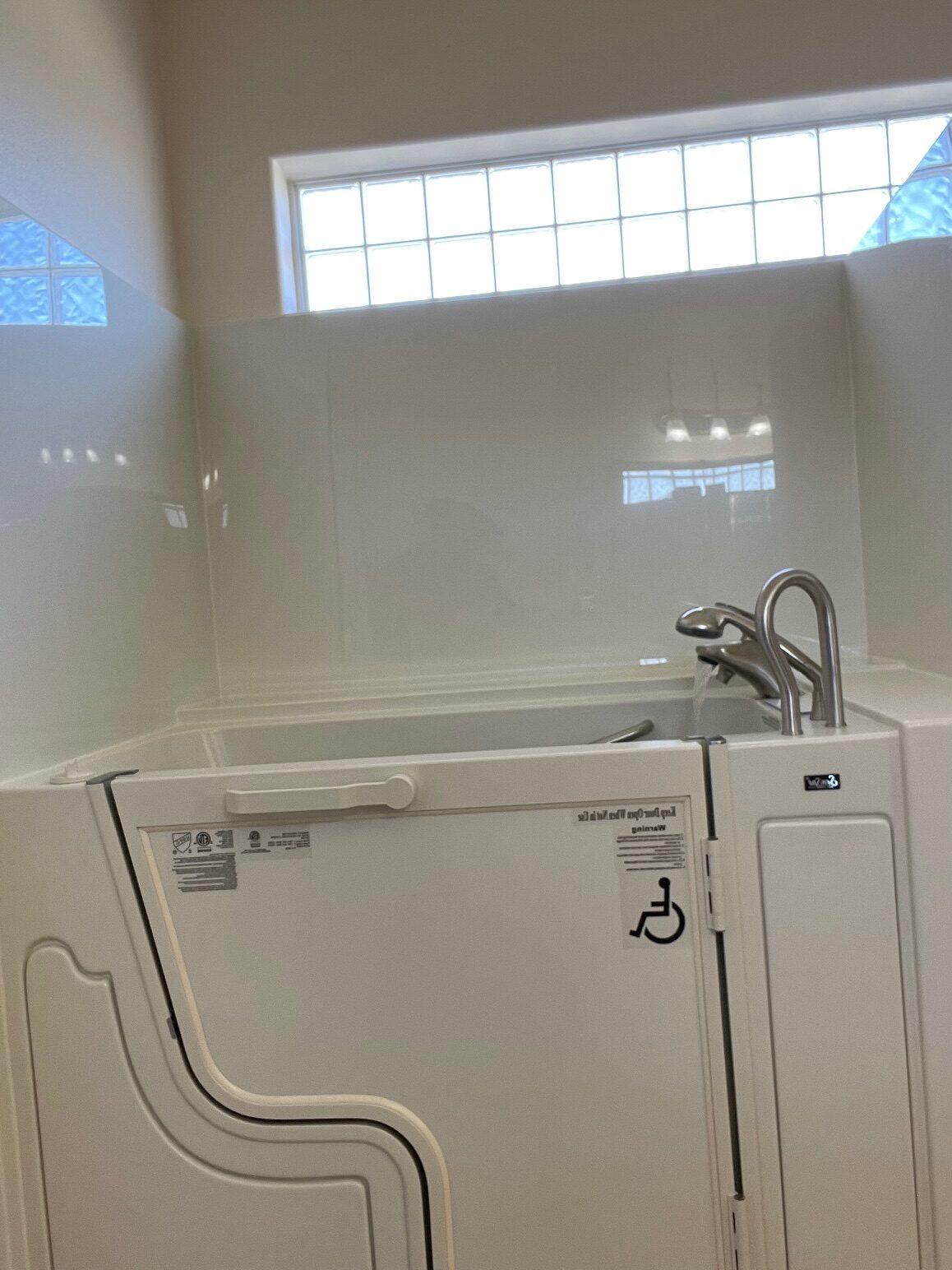 White walk-in bathtub replacement in bathroom to ensure accessibility