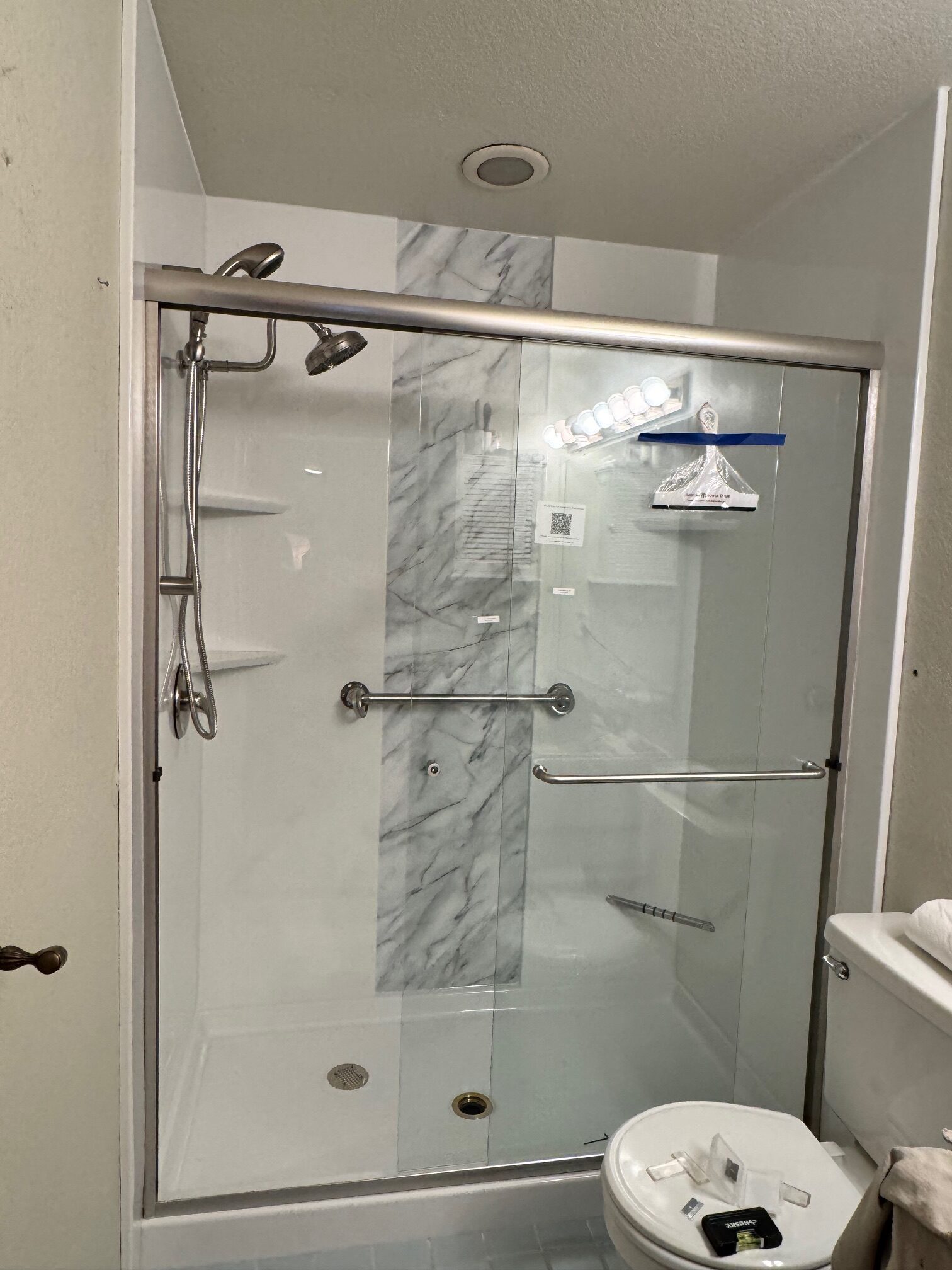 Walk-in shower with grab bars and low threshold