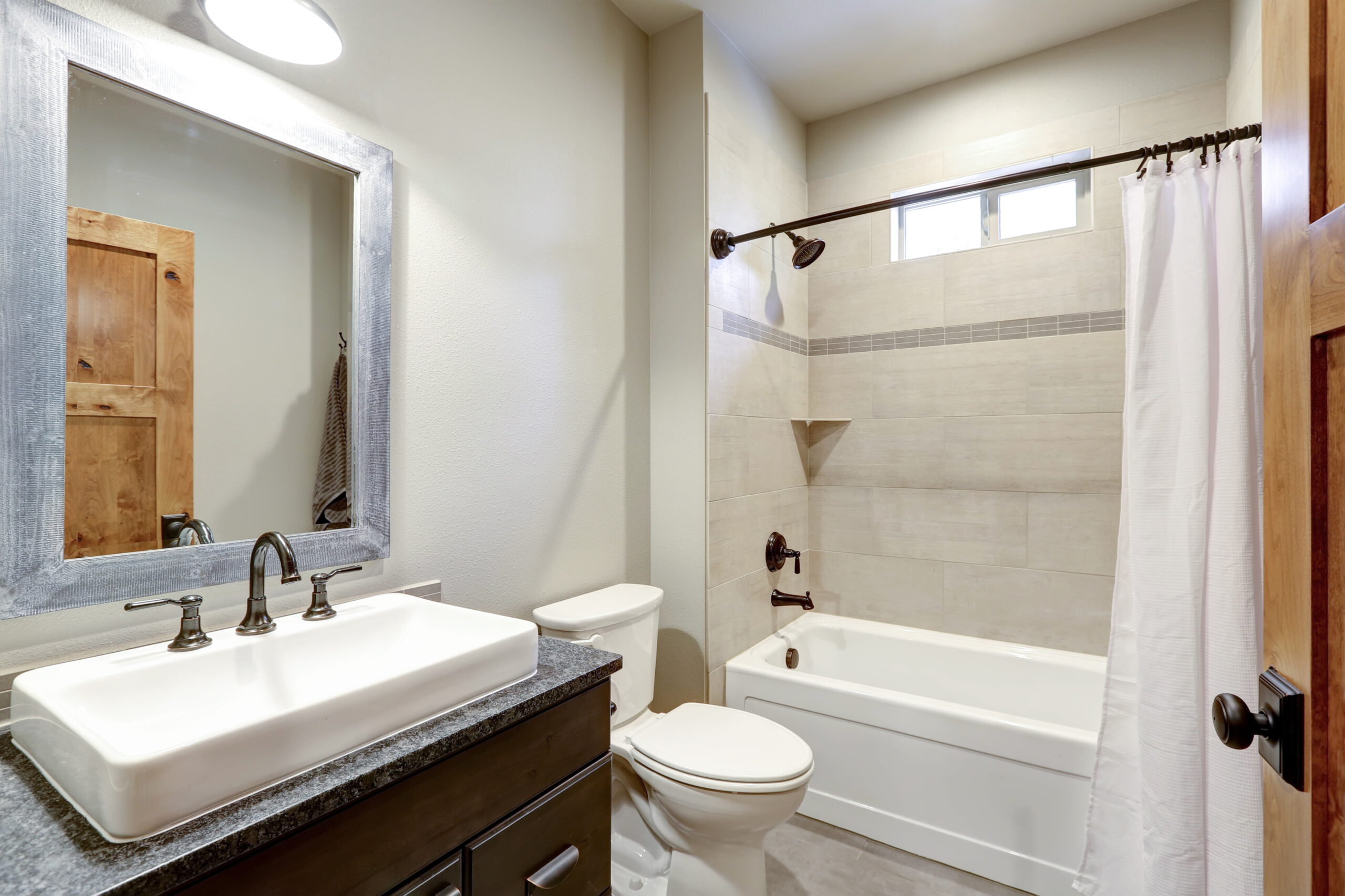 Charming bathroom with a basin sink vanity and a new bathtub