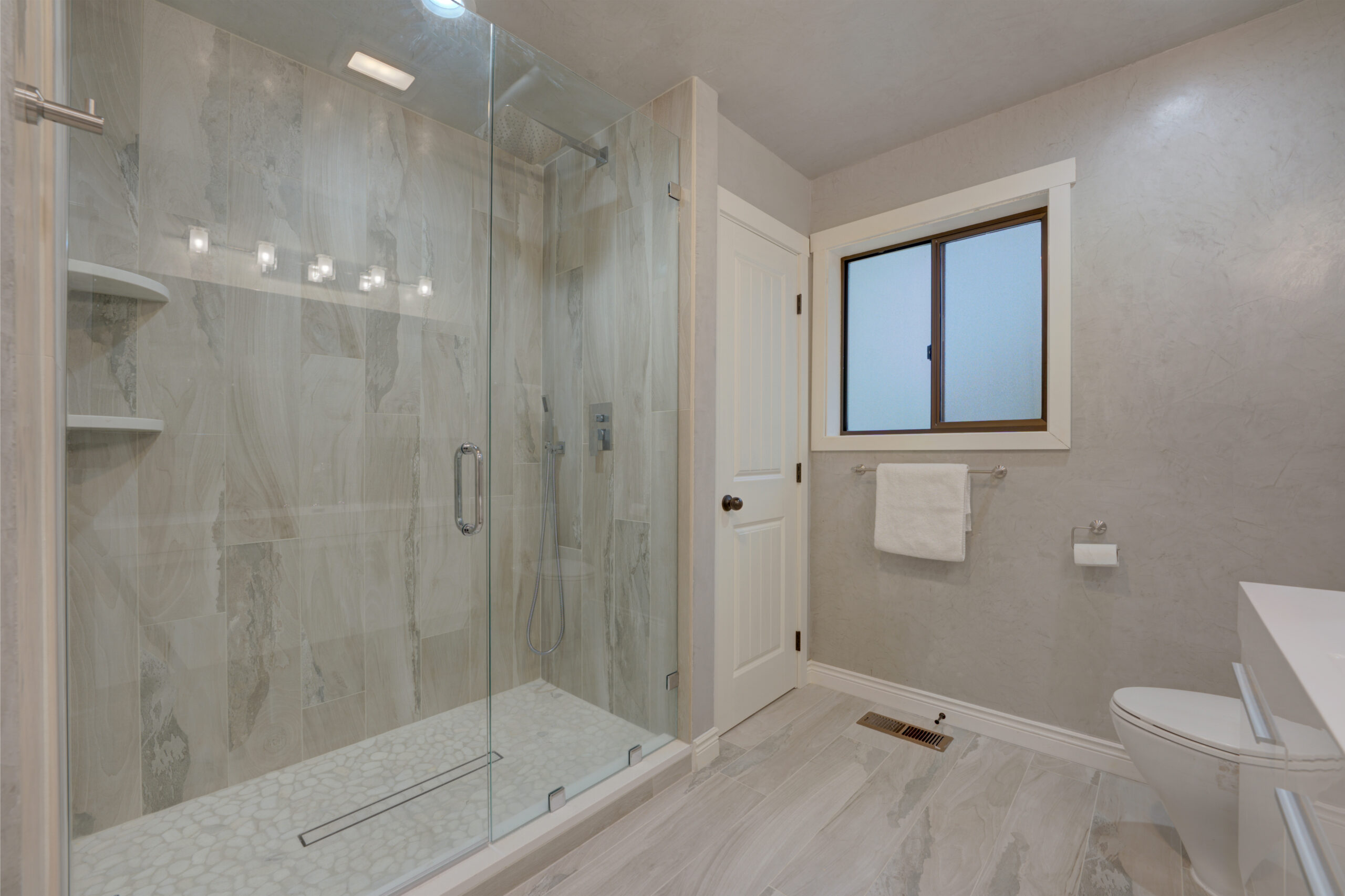 Modern bathroom with gray Venetian plaster walls