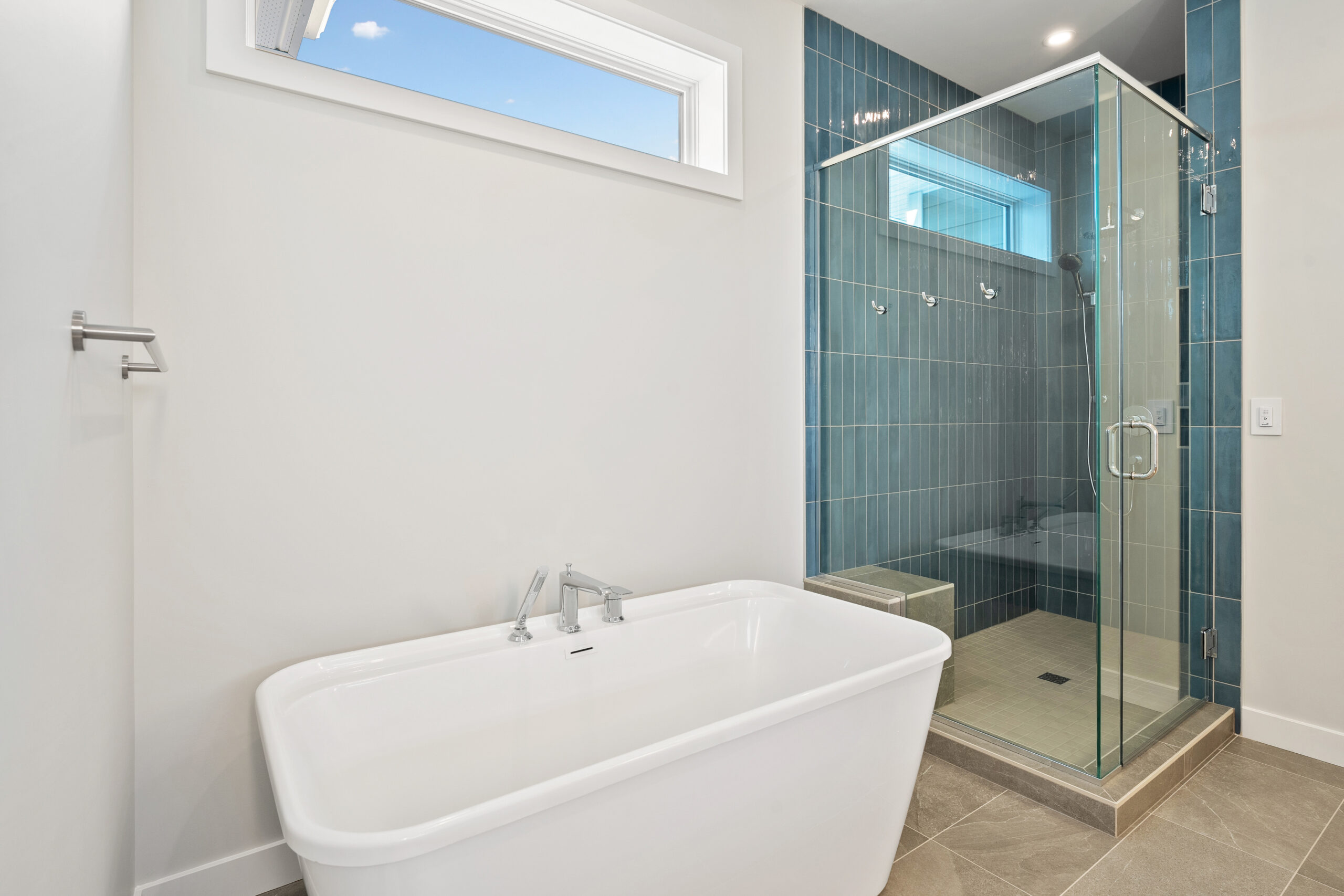 Cozy bathroom featuring a modern walk-in shower and a standalone soaking tub