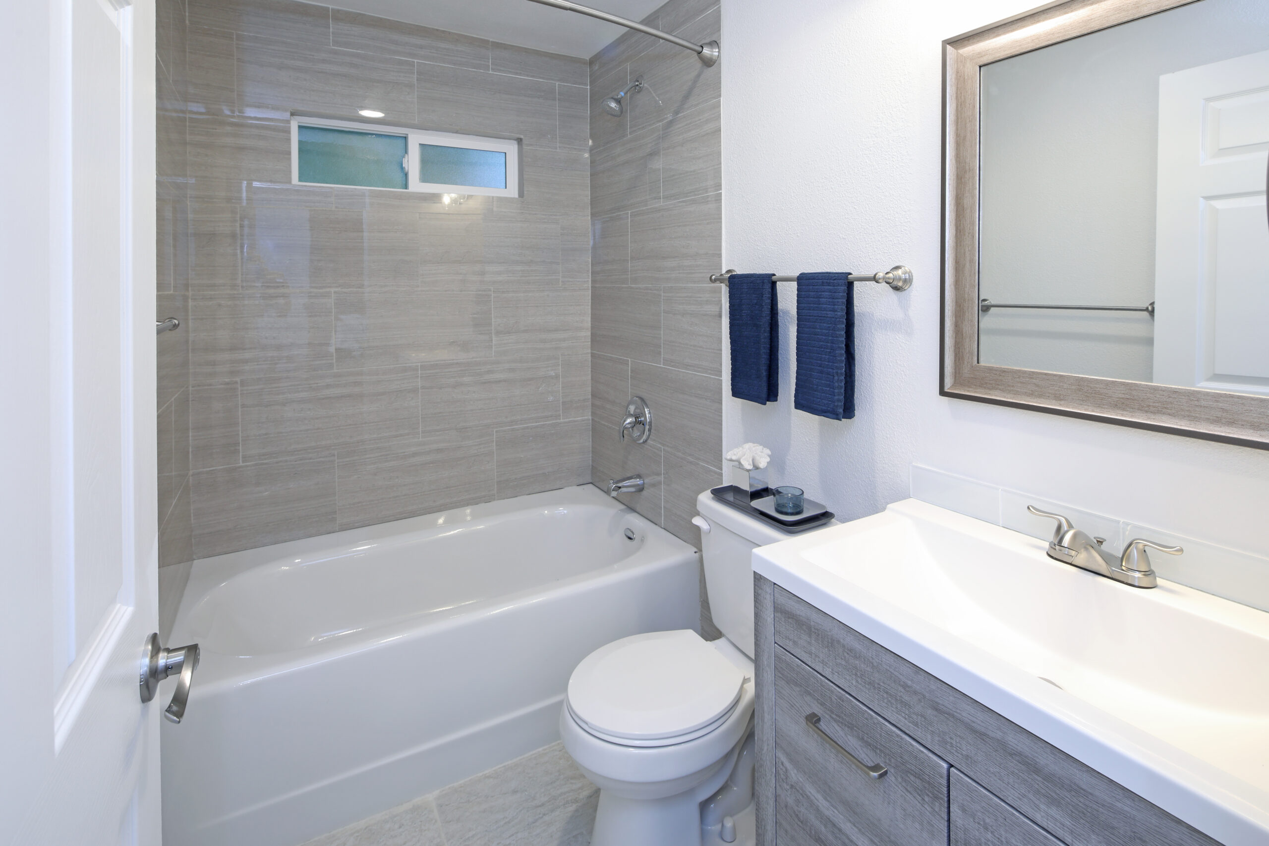 Bathtub with gray backsplash and modern fixtures