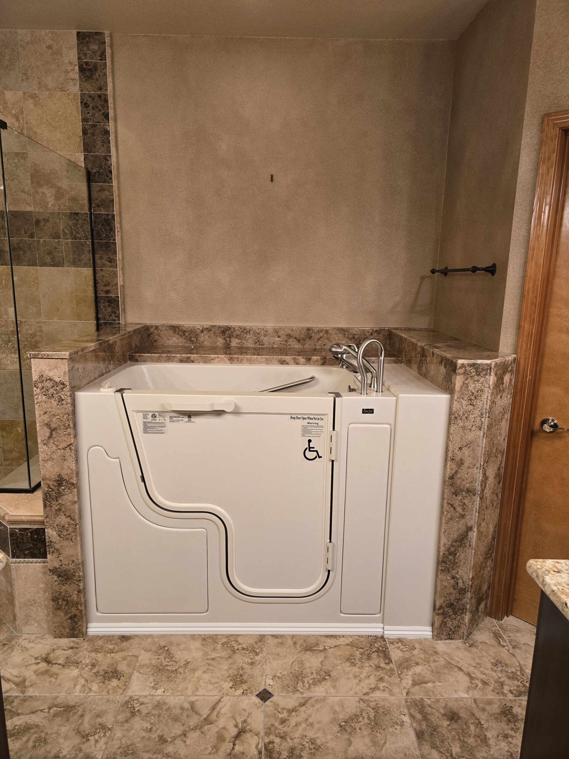 Walk-in shower with grab bars and low threshold