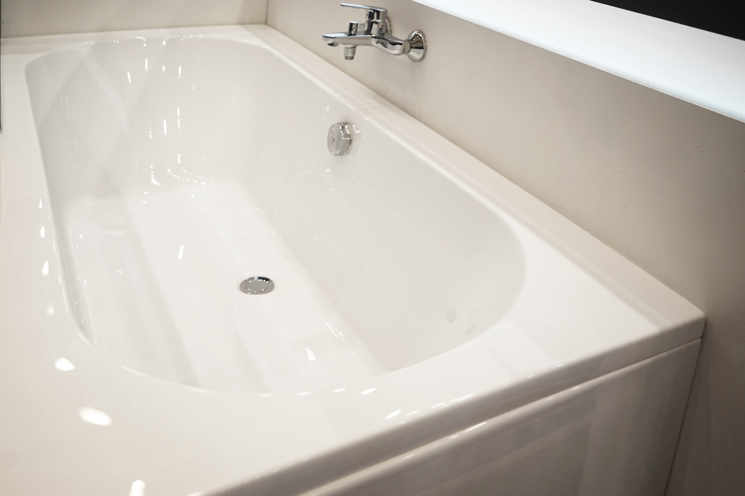 Beautiful new white bathtub installed in bathroom