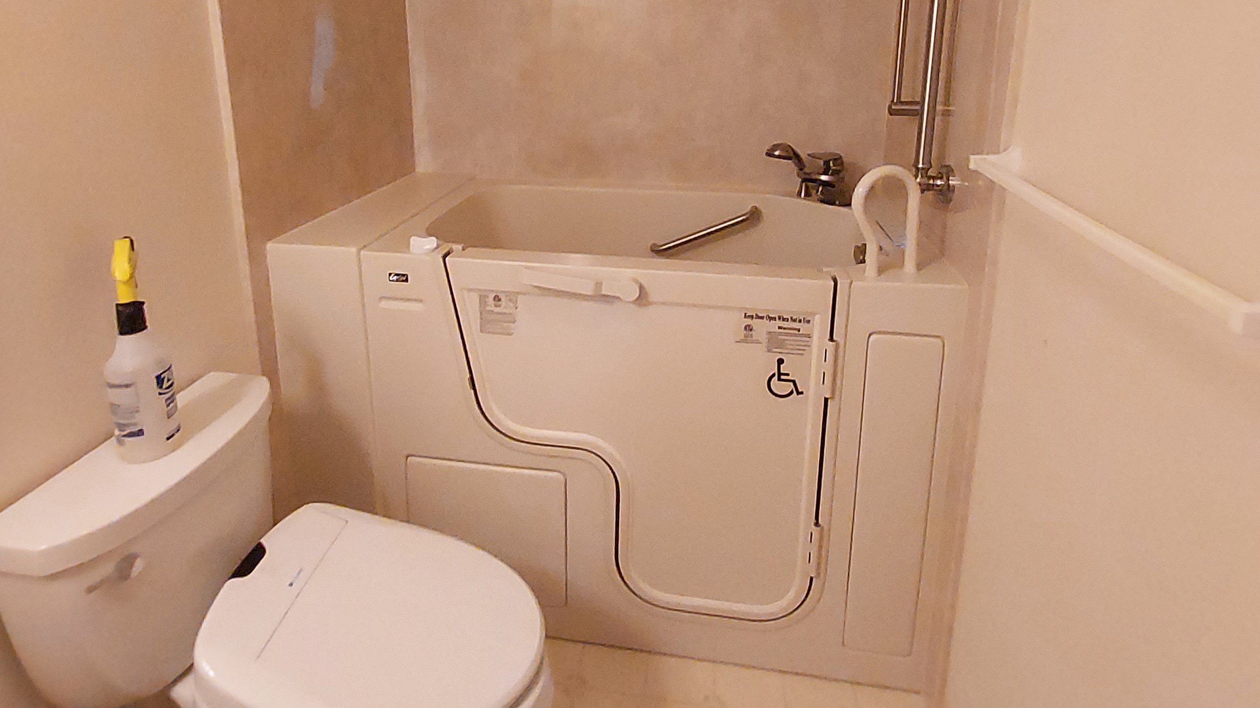Luxurious walk-in bath tub in white bathroom