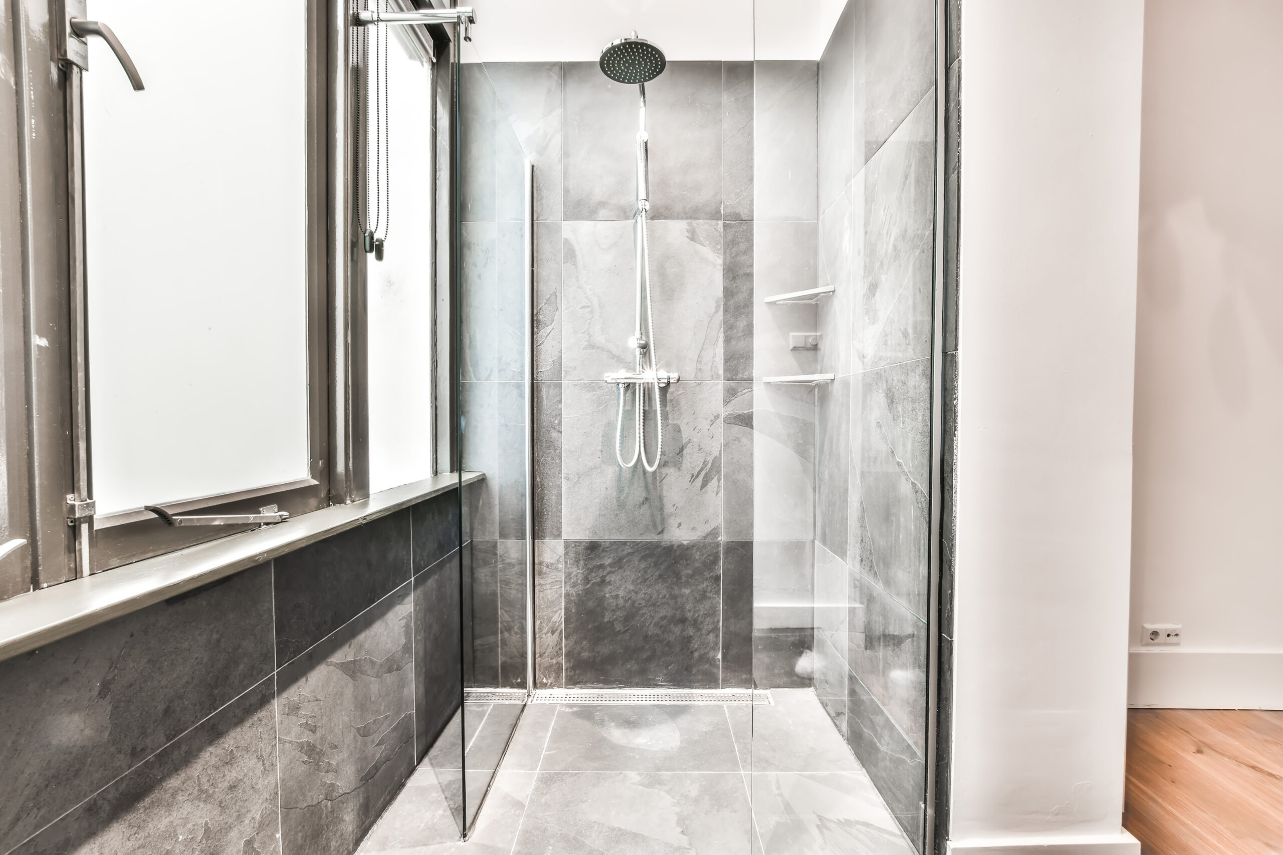 This image features a beautifully designed glass-enclosed walk-in shower.