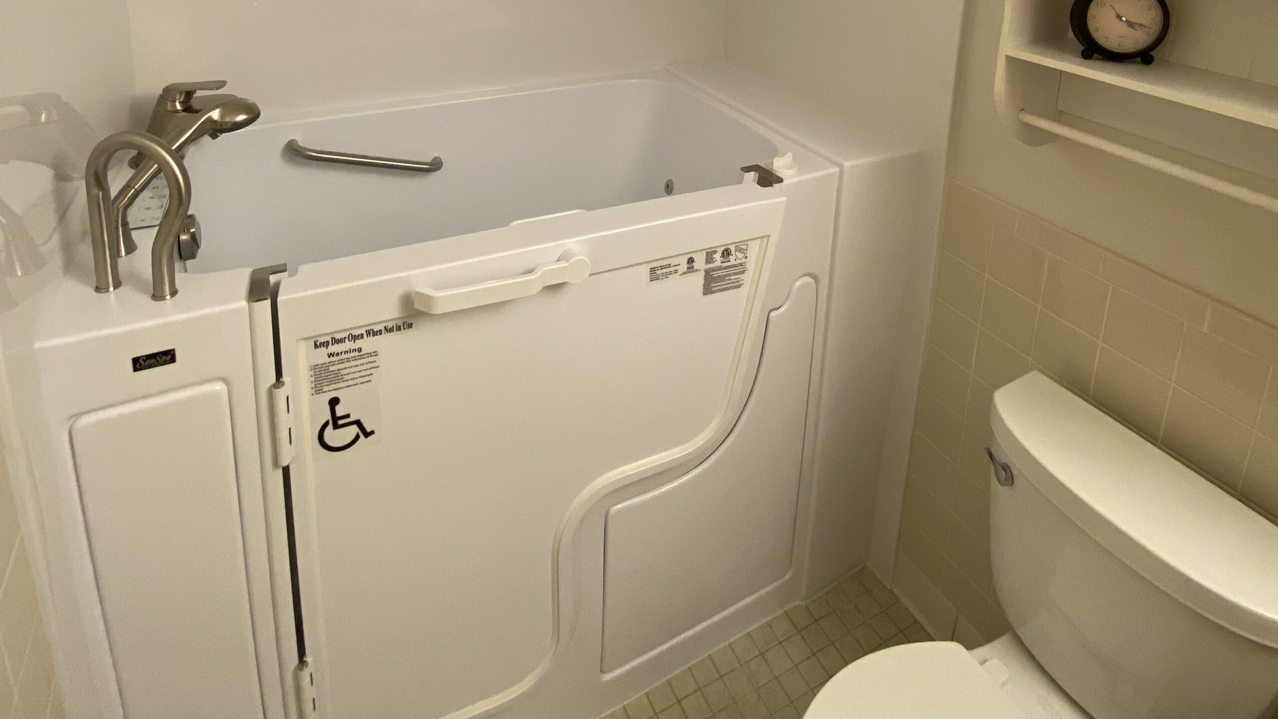 Luxurious walk-in bath tub in white bathroom