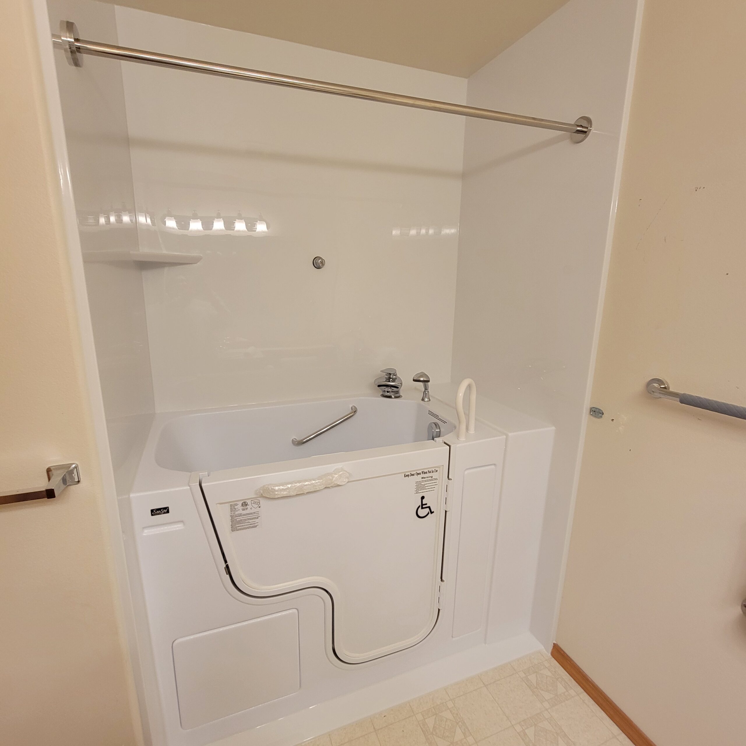 This is a bright and spacious bathroom featuring a modern walk-in tub.