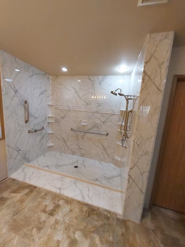 Image of a large shower with multiple grab bars