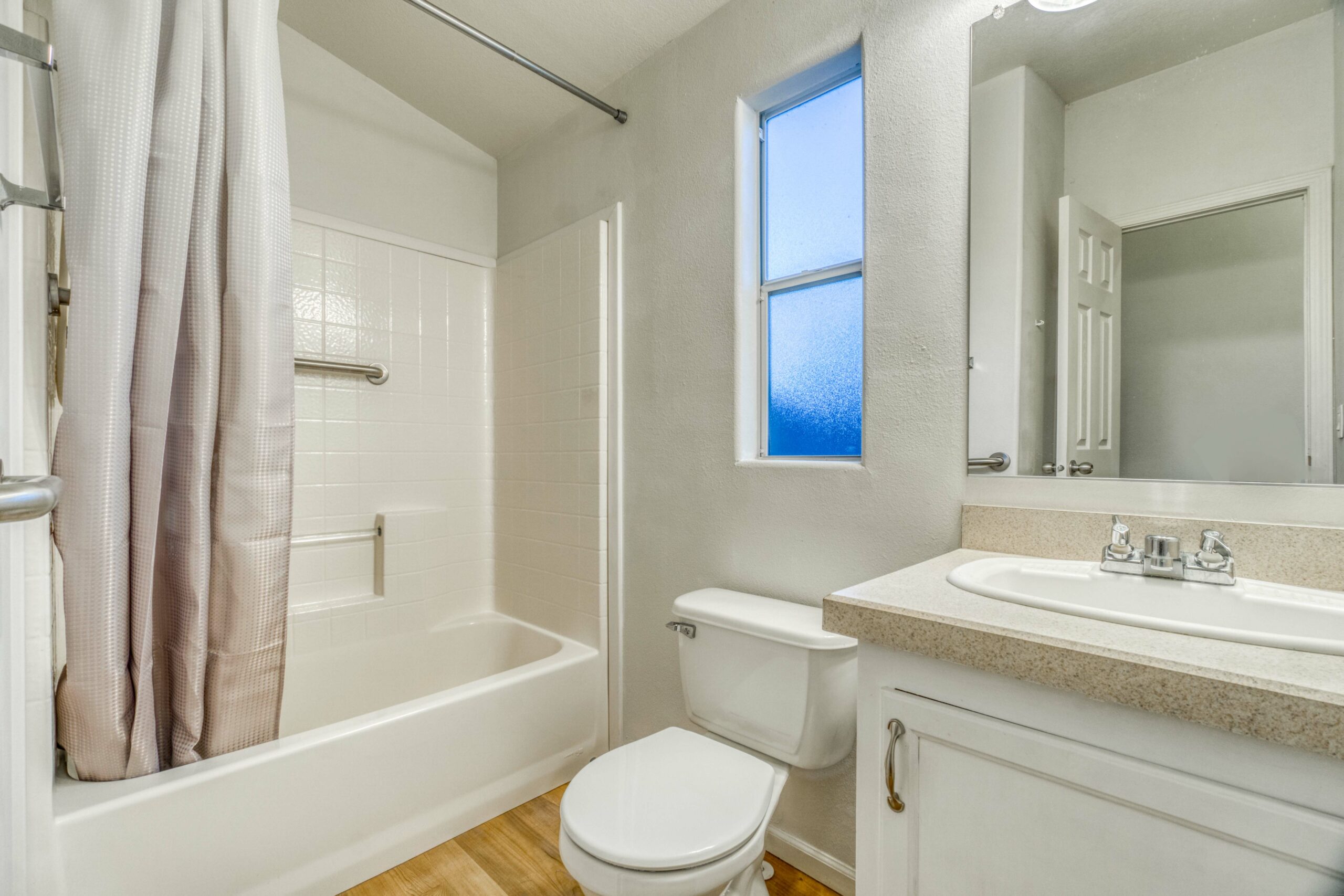 New bathtub with modern fixtures and a shower curtain